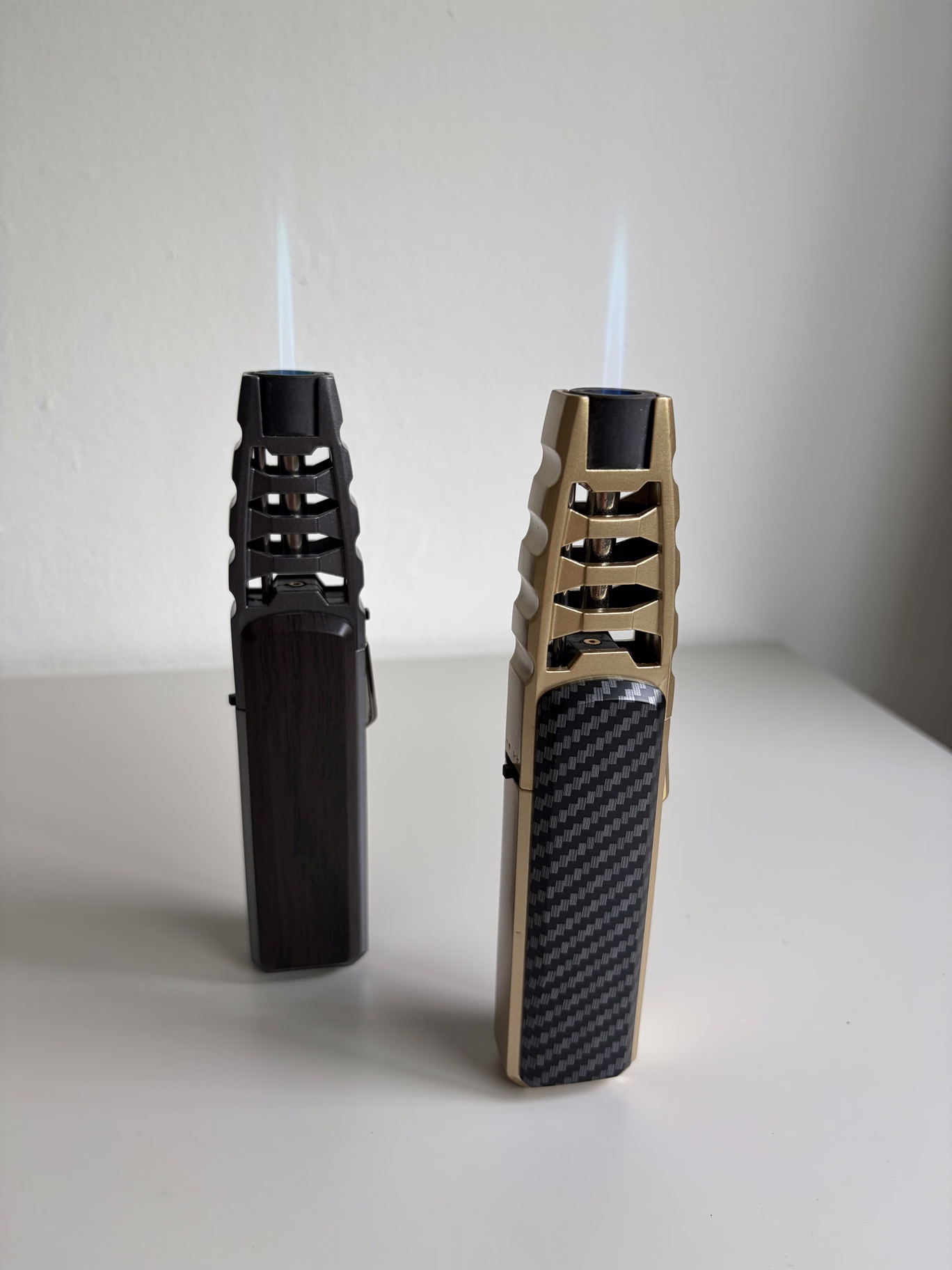 The two torch lighters with visible blue flames.